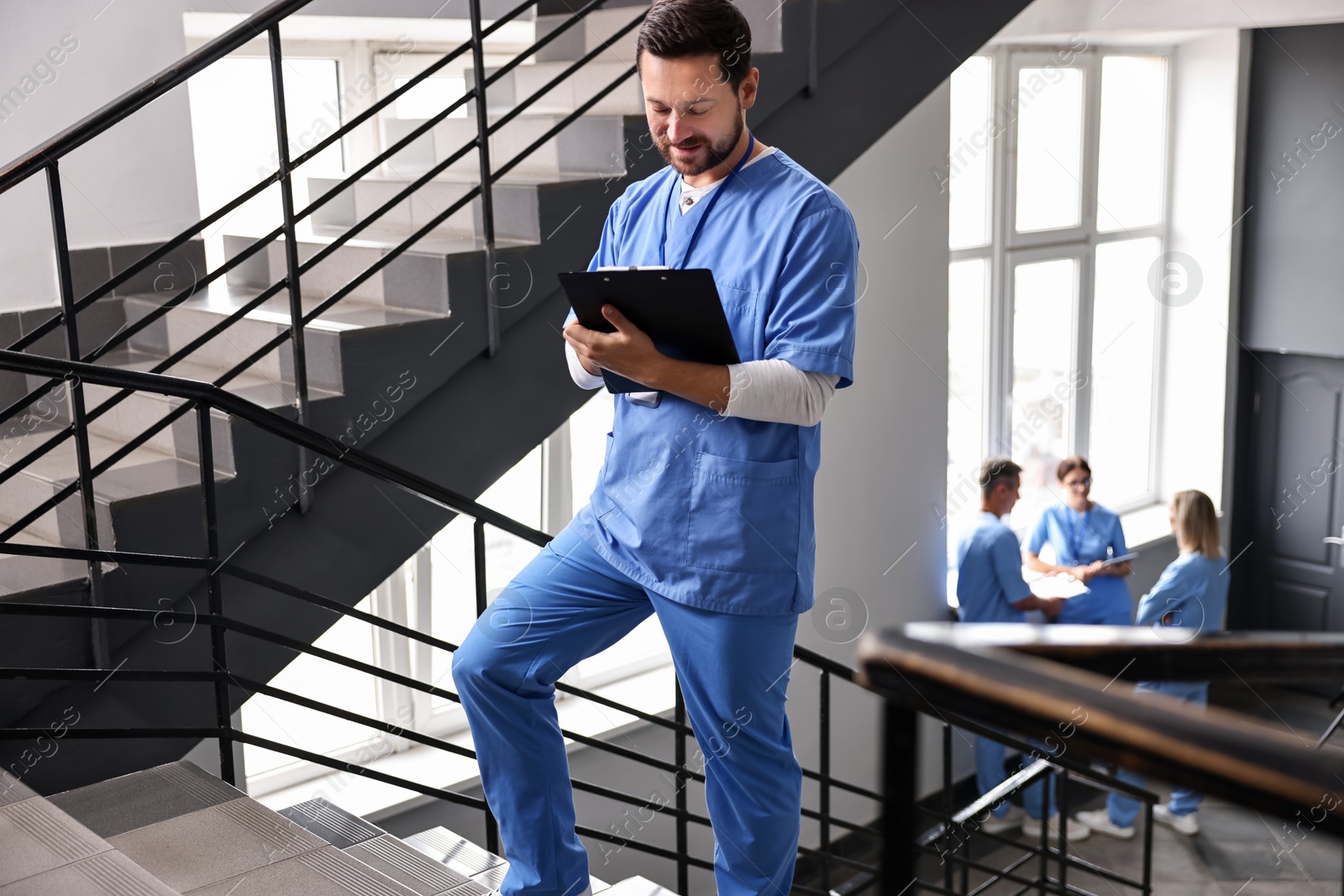 Photo of Healthcare workers in hospital, selective focus. Nurse with clipboard indoors