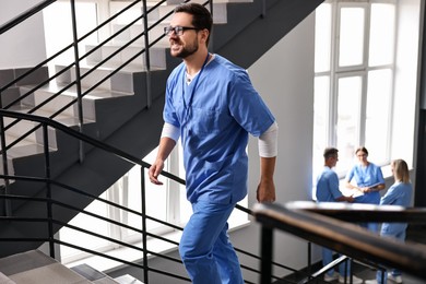 Photo of Healthcare worker walking up stairs in hospital