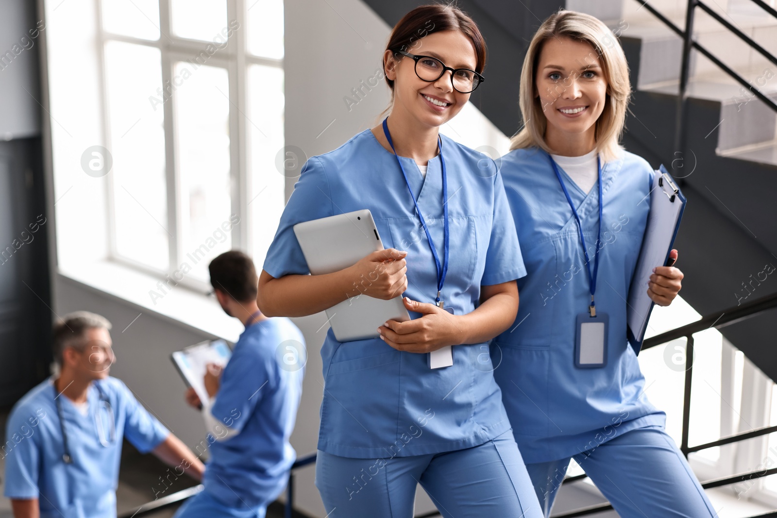 Photo of Healthcare workers in hospital, selective focus. Nurses with clipboard and tablet indoors