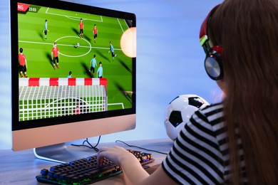 Girl playing video game with keyboard at table indoors