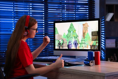 Photo of Girl watching game live stream at table with computer keyboard, cans and mouse