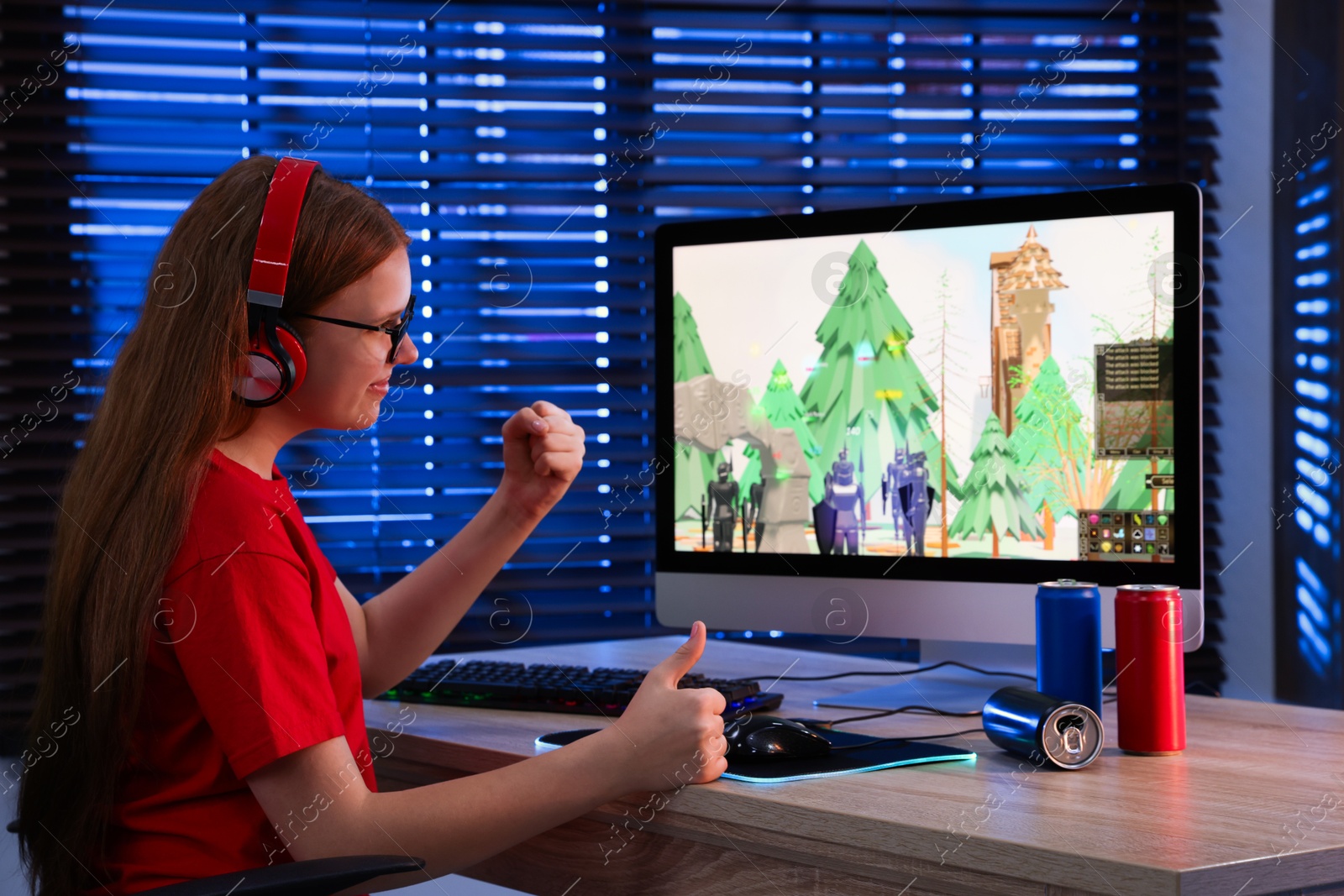 Photo of Girl watching game live stream at table with computer keyboard, cans and mouse