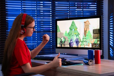 Photo of Girl watching game live stream at table with computer keyboard, cans and mouse