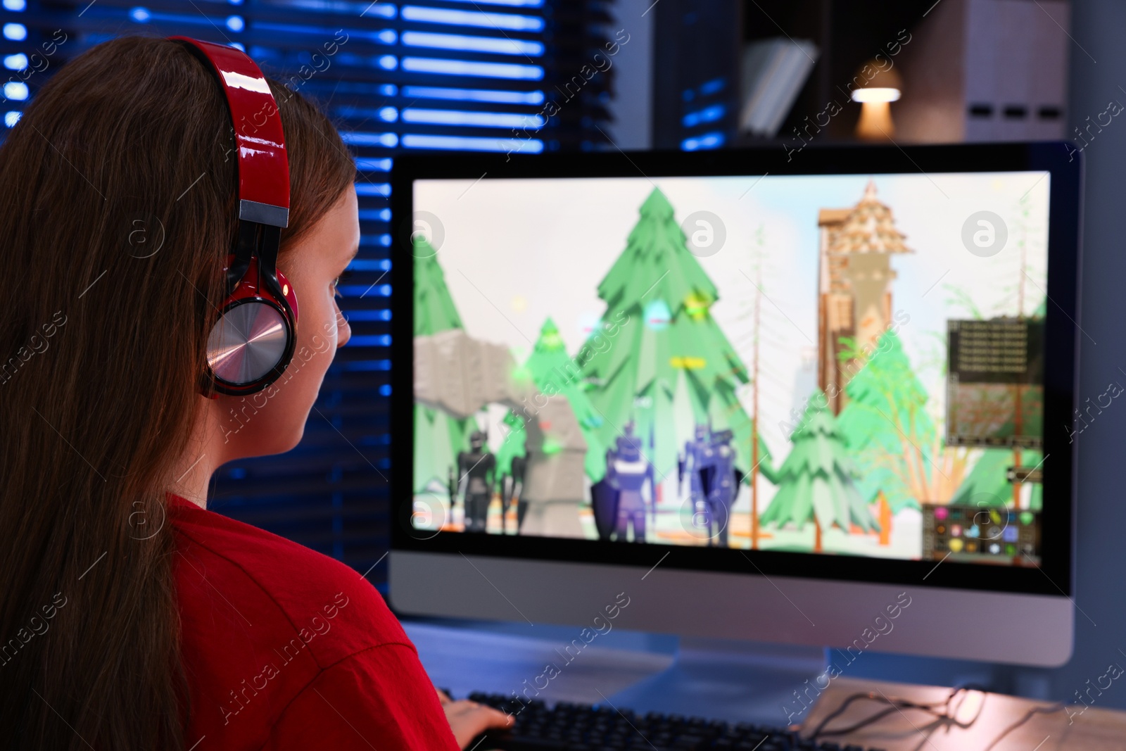 Photo of Girl watching game live stream at table with computer keyboard