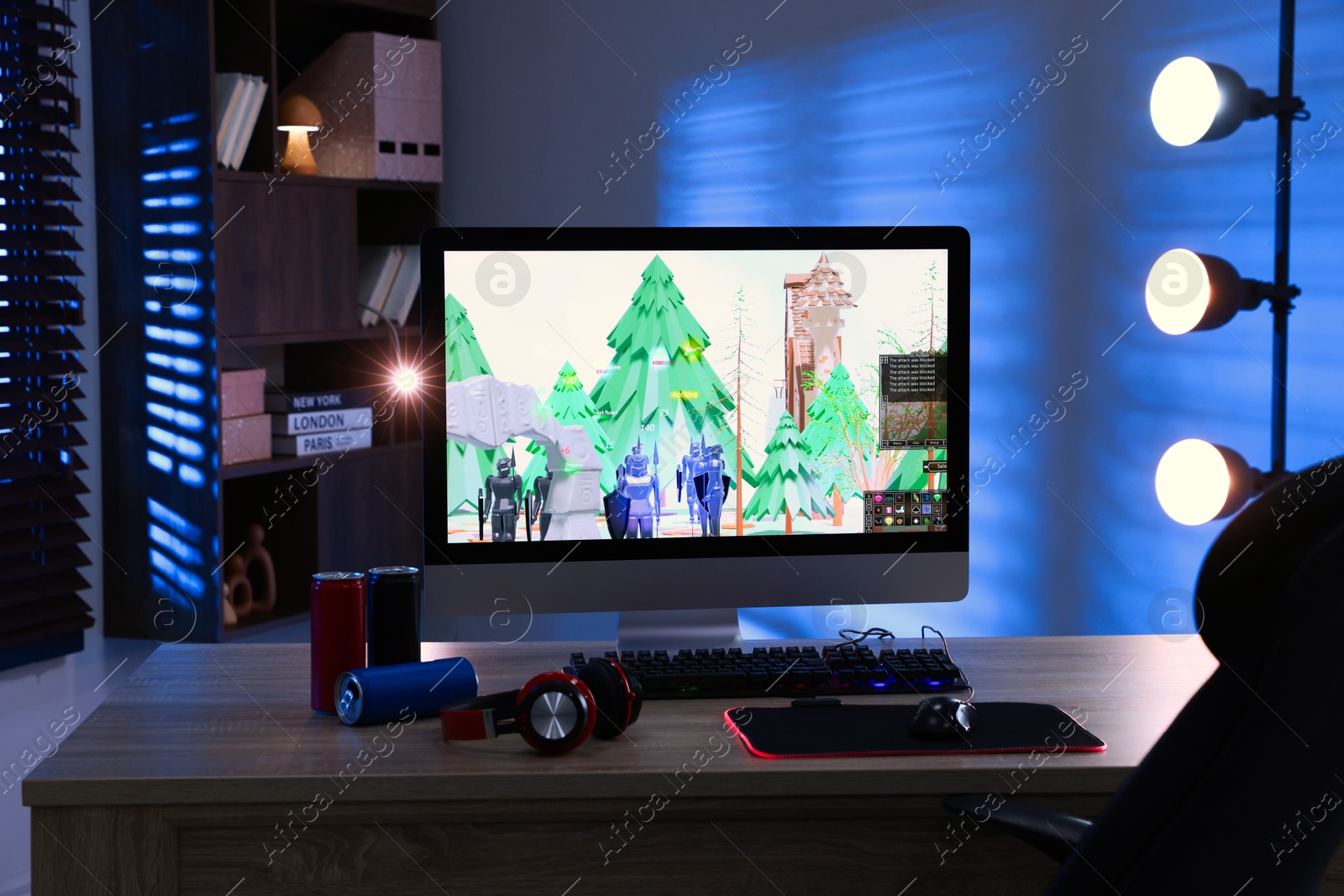 Photo of Computer keyboard, monitor, cans, headphones and mouse on table indoors