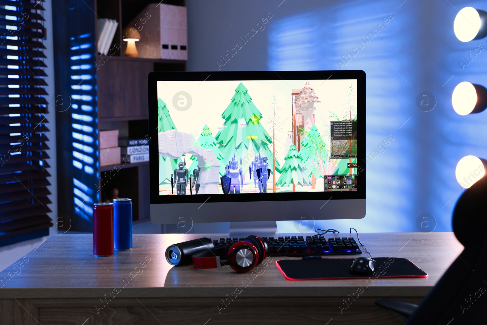 Photo of Computer keyboard, monitor, cans, headphones and mouse on table indoors