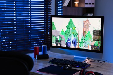 Photo of Computer keyboard, monitor, cans, headphones and mouse on table indoors