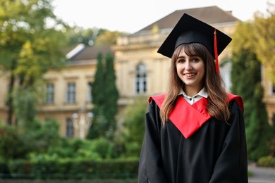 Graduation ceremony. Happy student outdoors, space for text