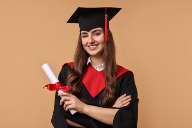 Photo of Happy student with diploma after graduation on beige background