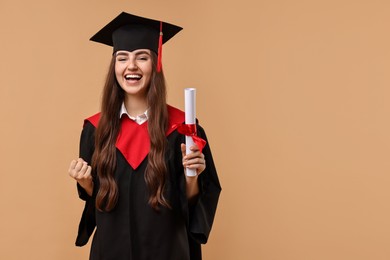 Photo of Happy student with diploma after graduation on beige background. Space for text