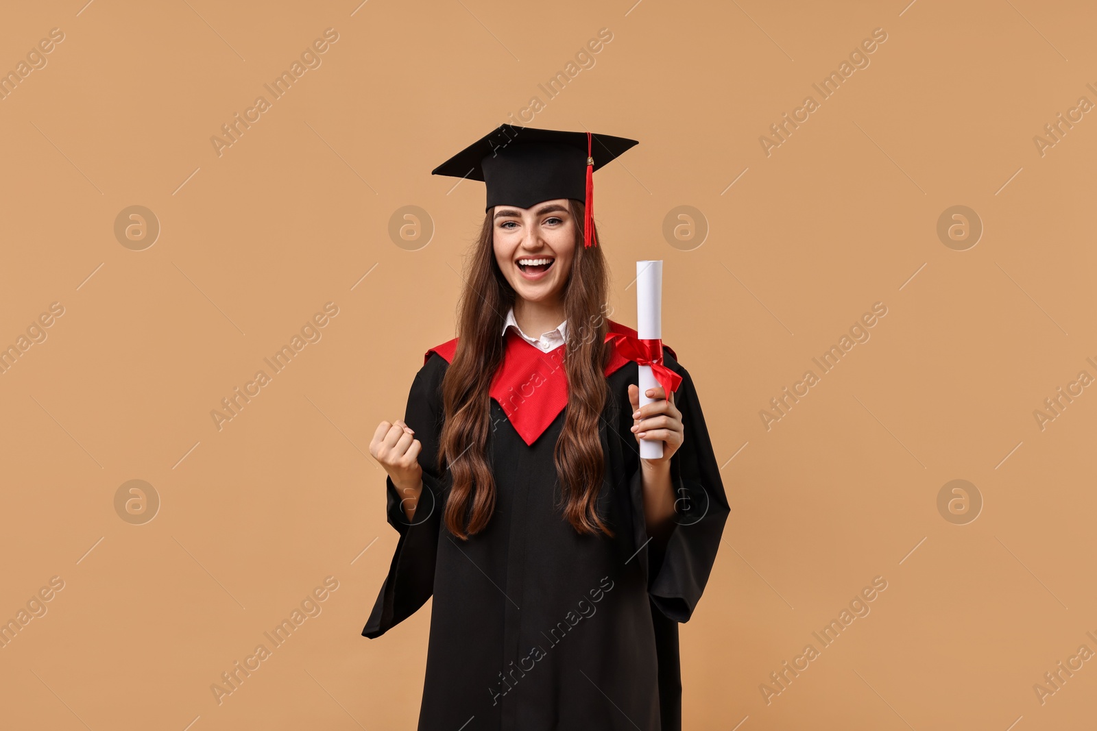 Photo of Happy student with diploma after graduation on beige background