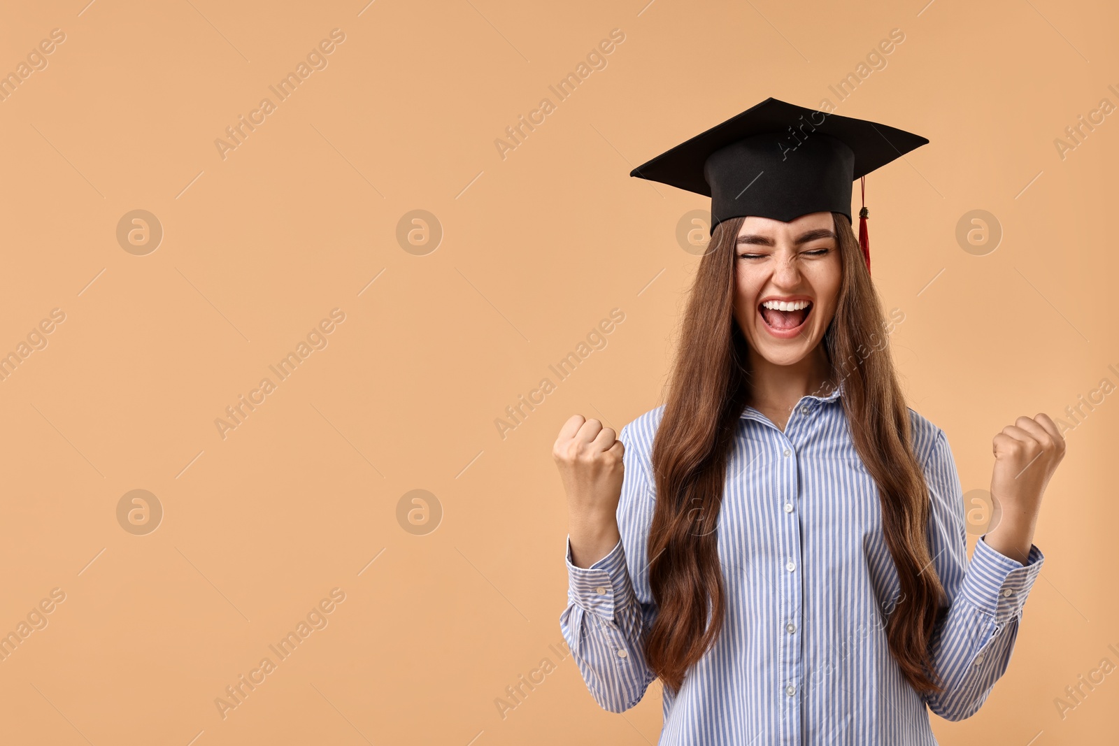 Photo of Happy student after graduation on beige background. Space for text