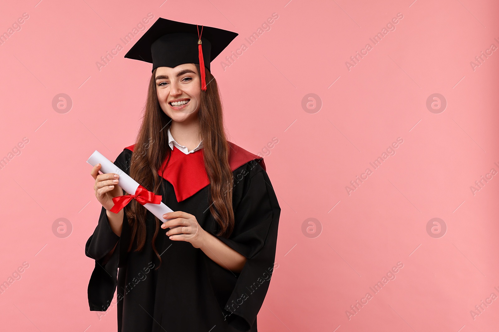 Photo of Happy student with diploma after graduation on pink background. Space for text