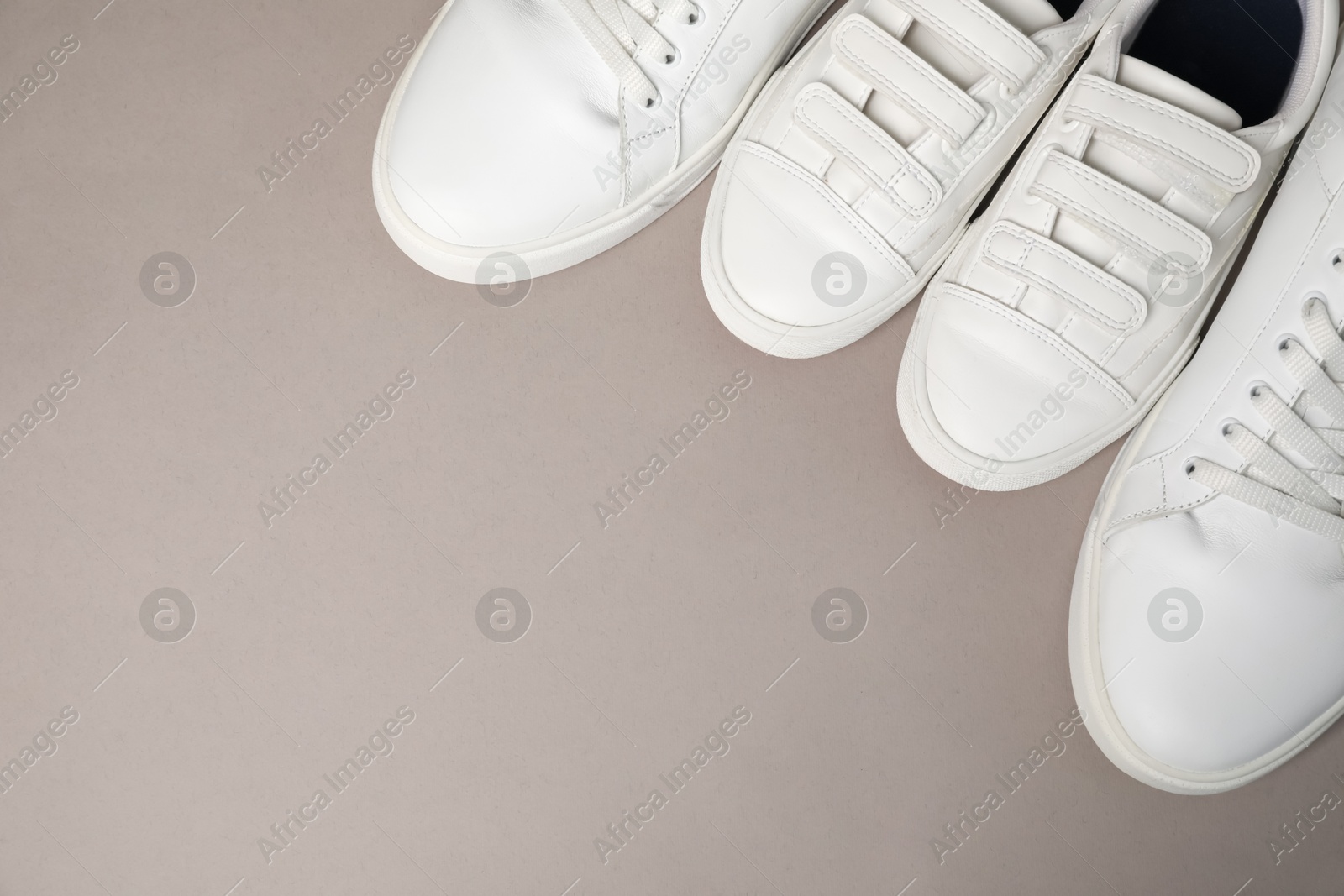 Photo of Big and small shoes on grey background, top view. Space for text