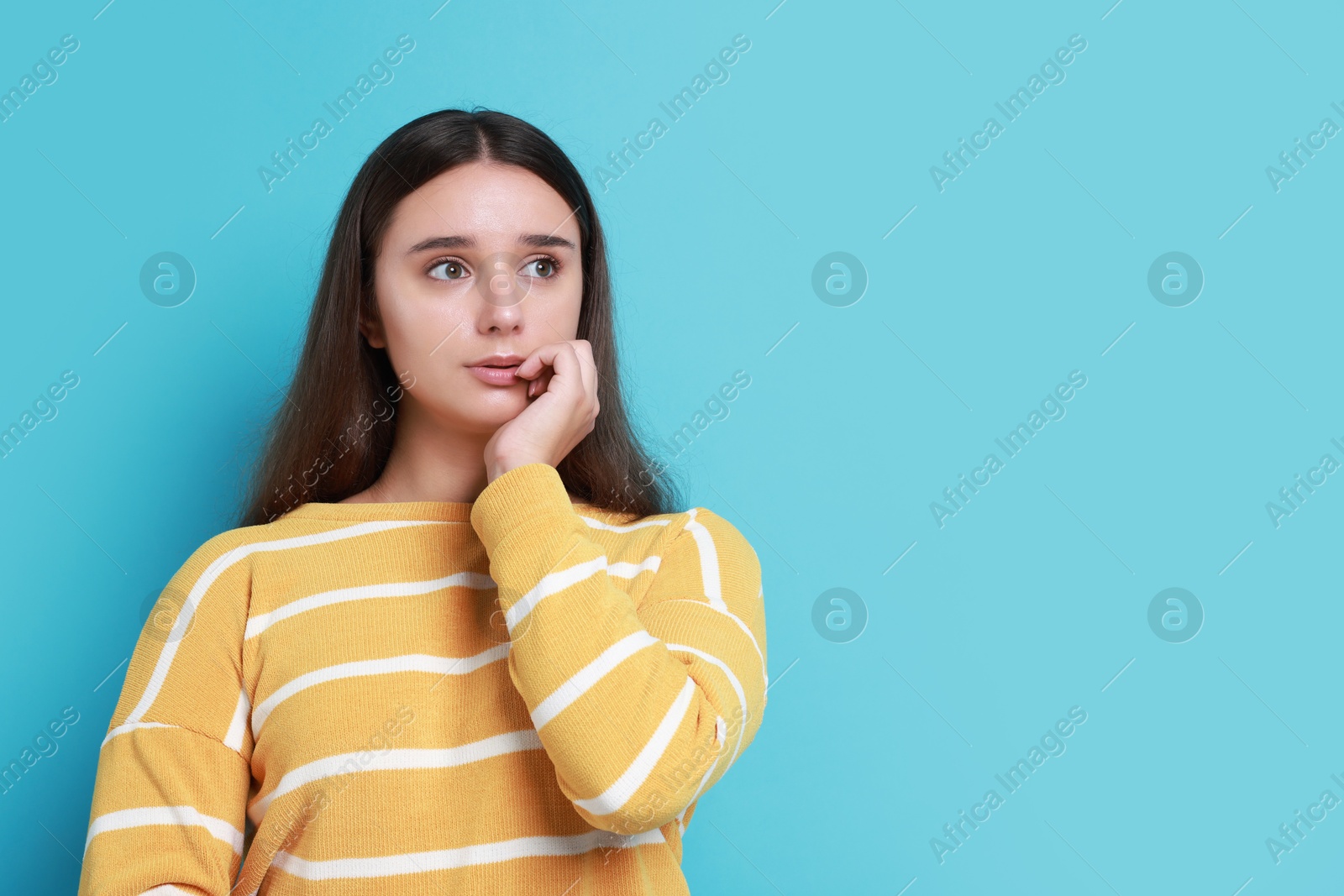 Photo of Stressful student before exam on light blue background, space for text