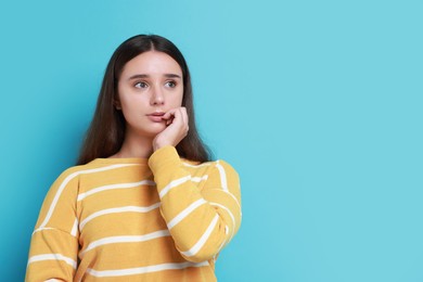 Photo of Stressful student before exam on light blue background, space for text