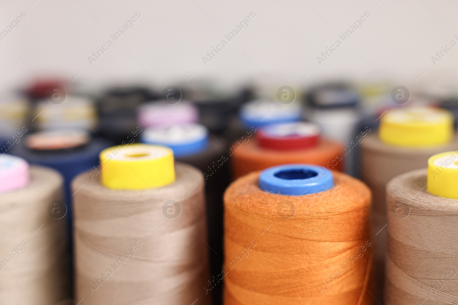 Photo of Many different spools of thread in professional workshop, closeup