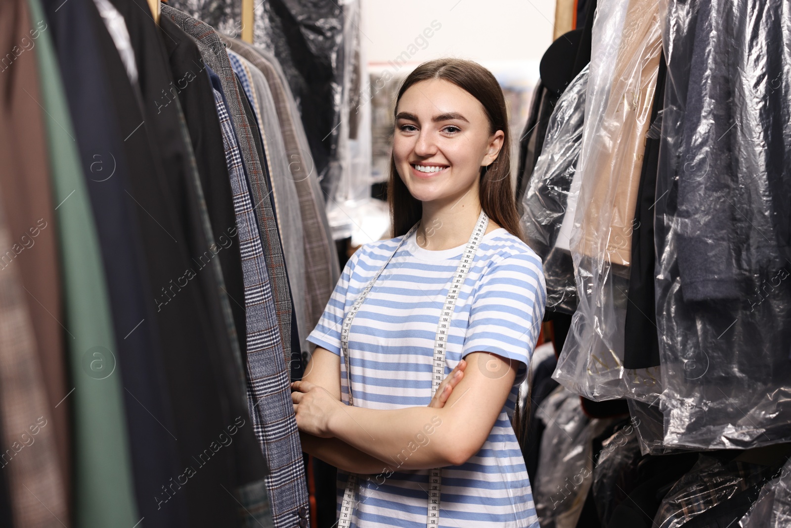 Photo of Stylish atelier. Young woman working in professional workshop