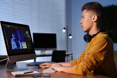 Photo of Designer working on computer indoors at night