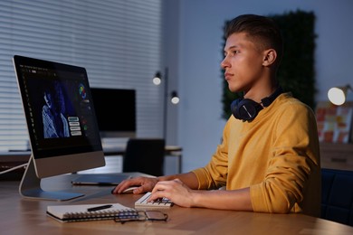 Photo of Designer working on computer indoors at night