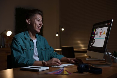 Photo of Designer working on computer indoors at night