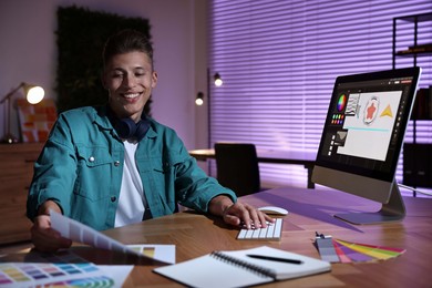 Photo of Designer with color palette working indoors at night