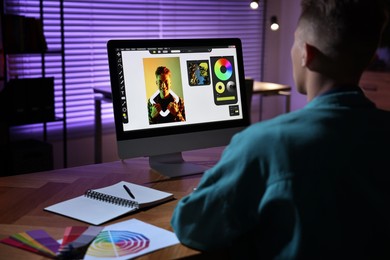 Designer working on computer indoors at night