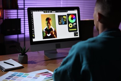 Photo of Designer working on computer indoors at night