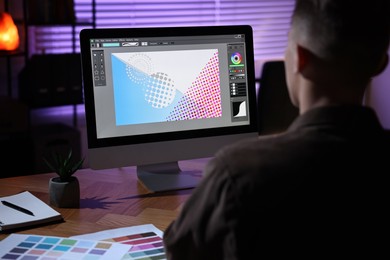 Photo of Designer working on computer indoors at night