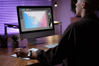 Photo of Designer working on computer indoors at night, closeup