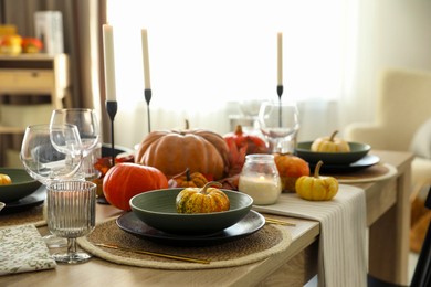 Stylish table setting with beautiful autumn decor in dining room