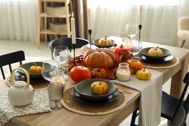 Stylish table setting with beautiful autumn decor in dining room