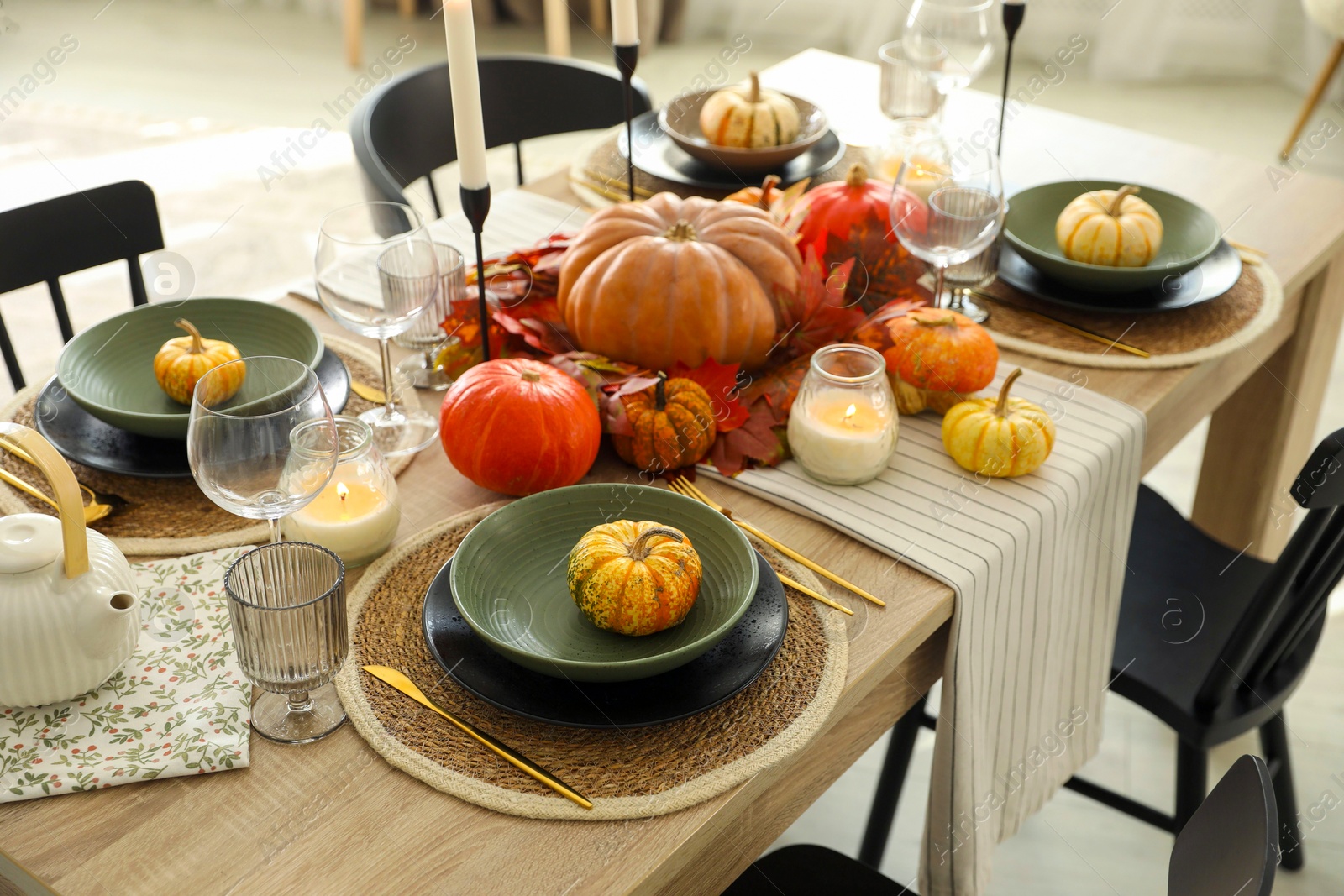 Photo of Stylish table setting with beautiful autumn decor in dining room