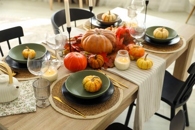 Stylish table setting with beautiful autumn decor in dining room