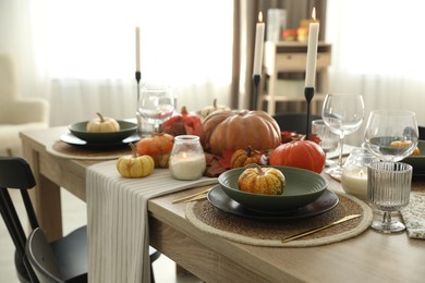 Stylish table setting with beautiful autumn decor in dining room