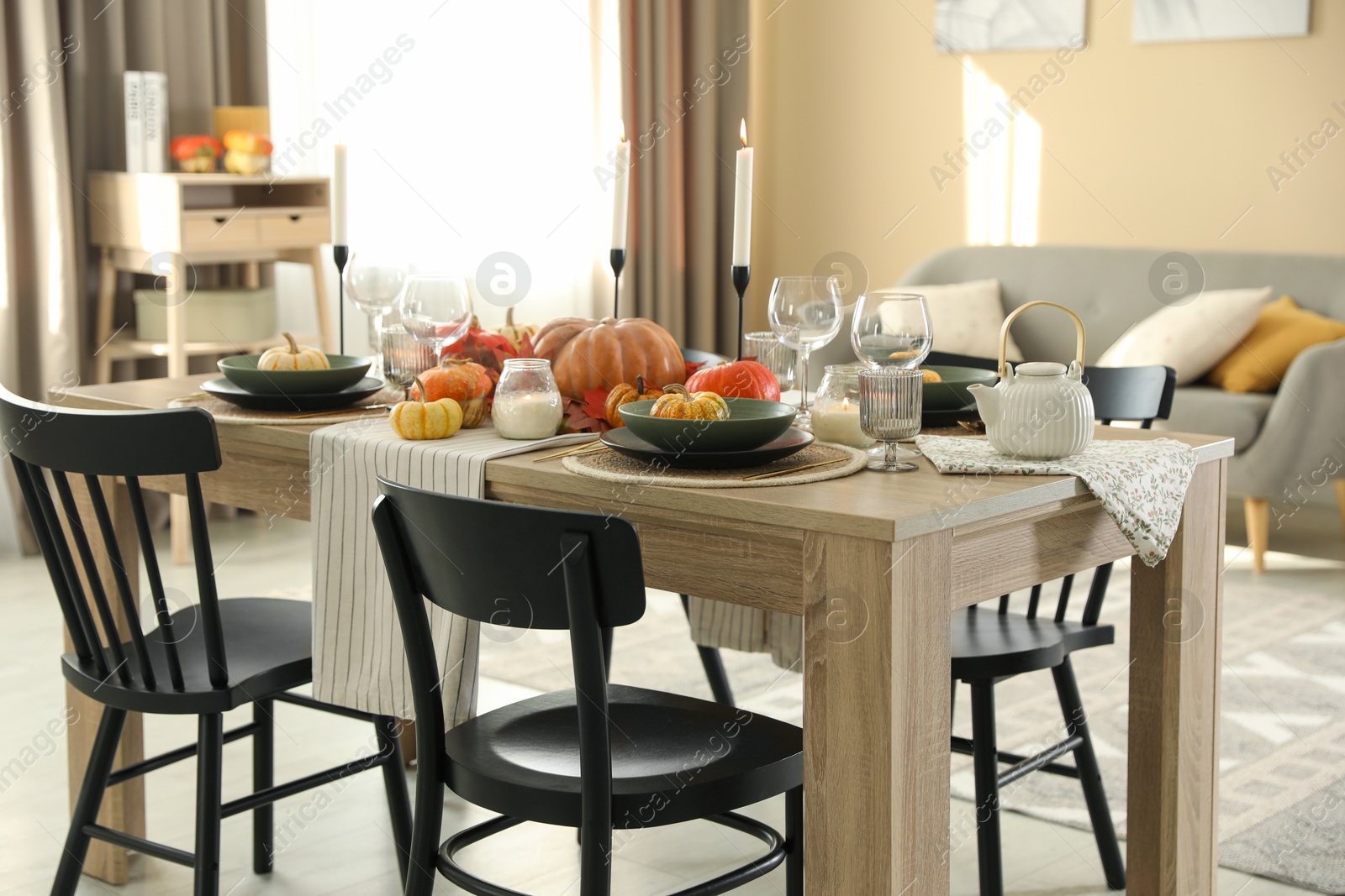 Photo of Stylish table setting with beautiful autumn decor in dining room