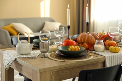 Stylish table setting with beautiful autumn decor in dining room