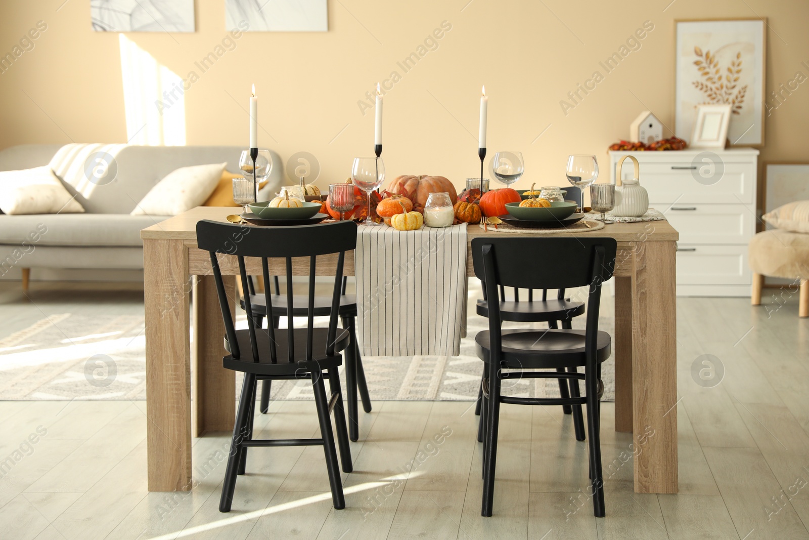 Photo of Stylish dining room with beautiful table setting and autumn decor