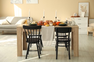 Stylish dining room with beautiful table setting and autumn decor