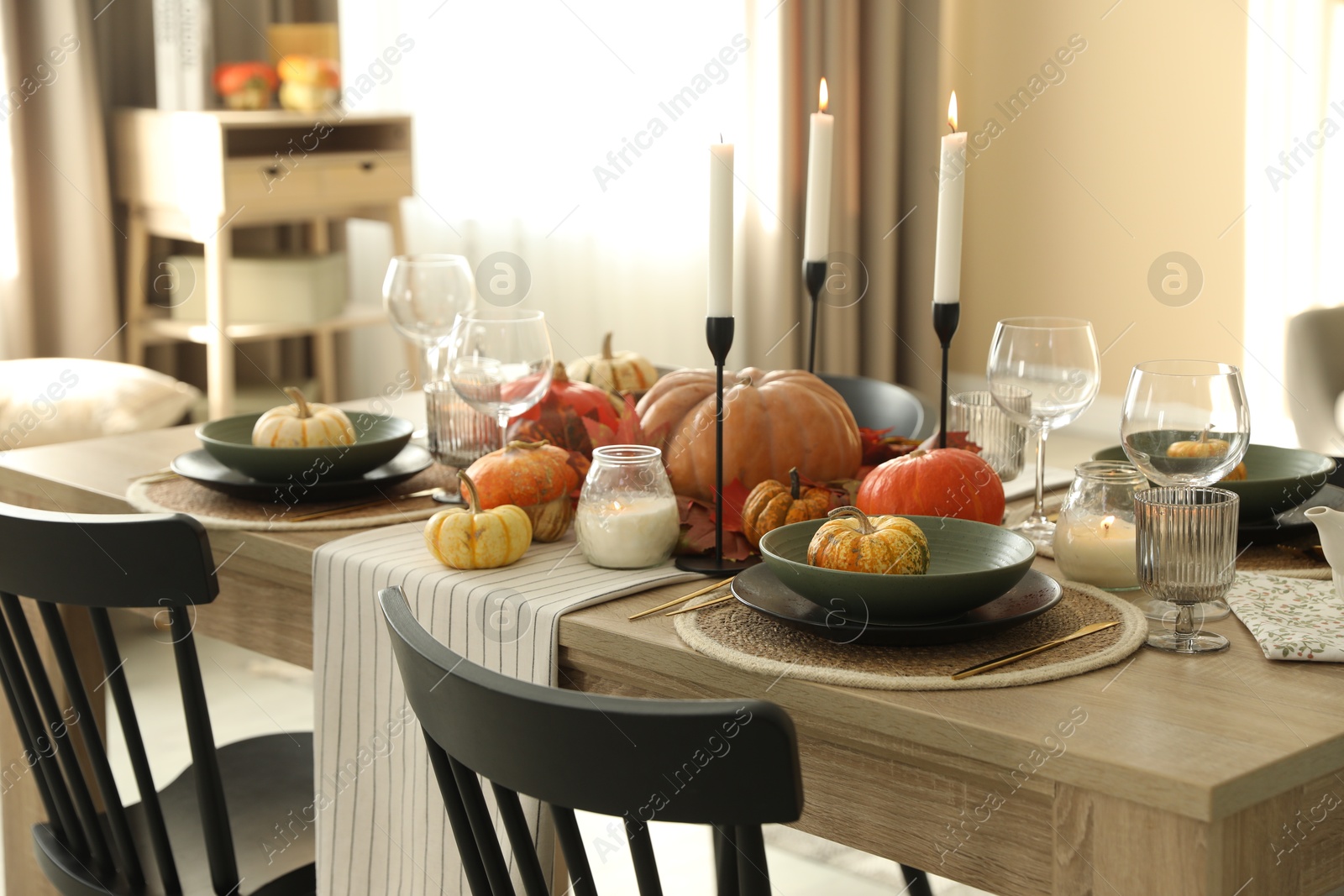 Photo of Stylish table setting with beautiful autumn decor in dining room