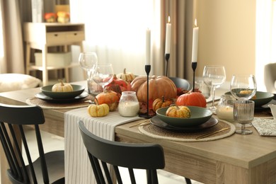 Stylish table setting with beautiful autumn decor in dining room