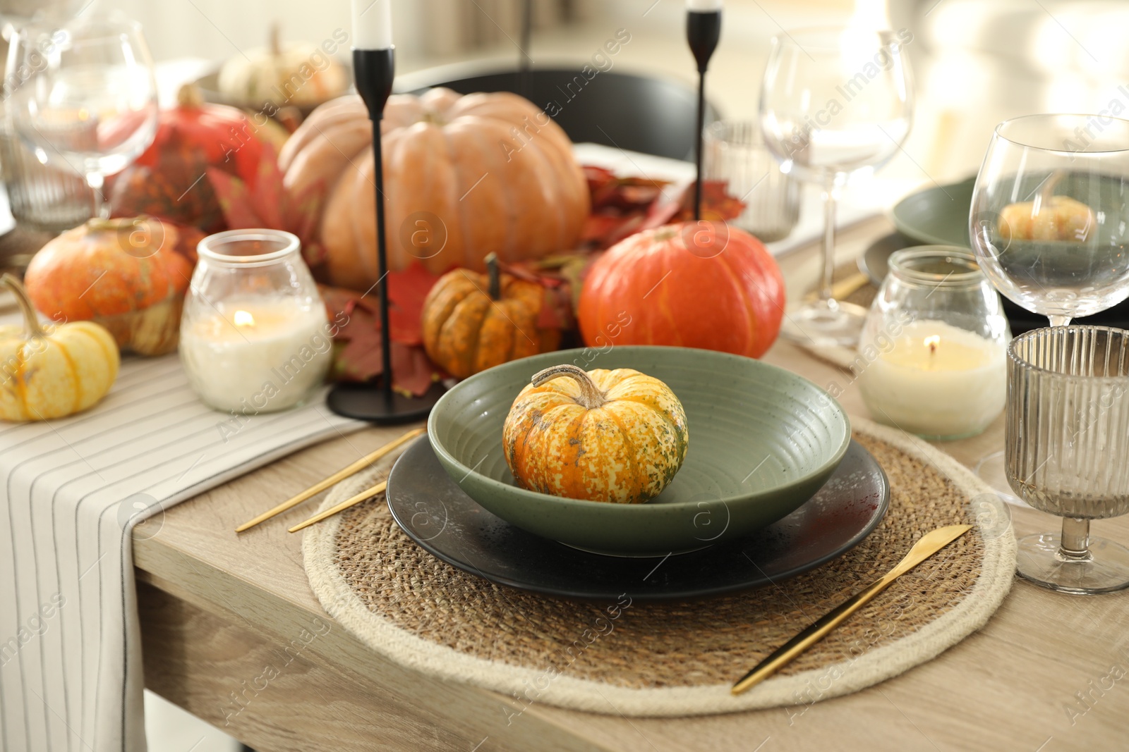 Photo of Stylish table setting with beautiful autumn decor in dining room