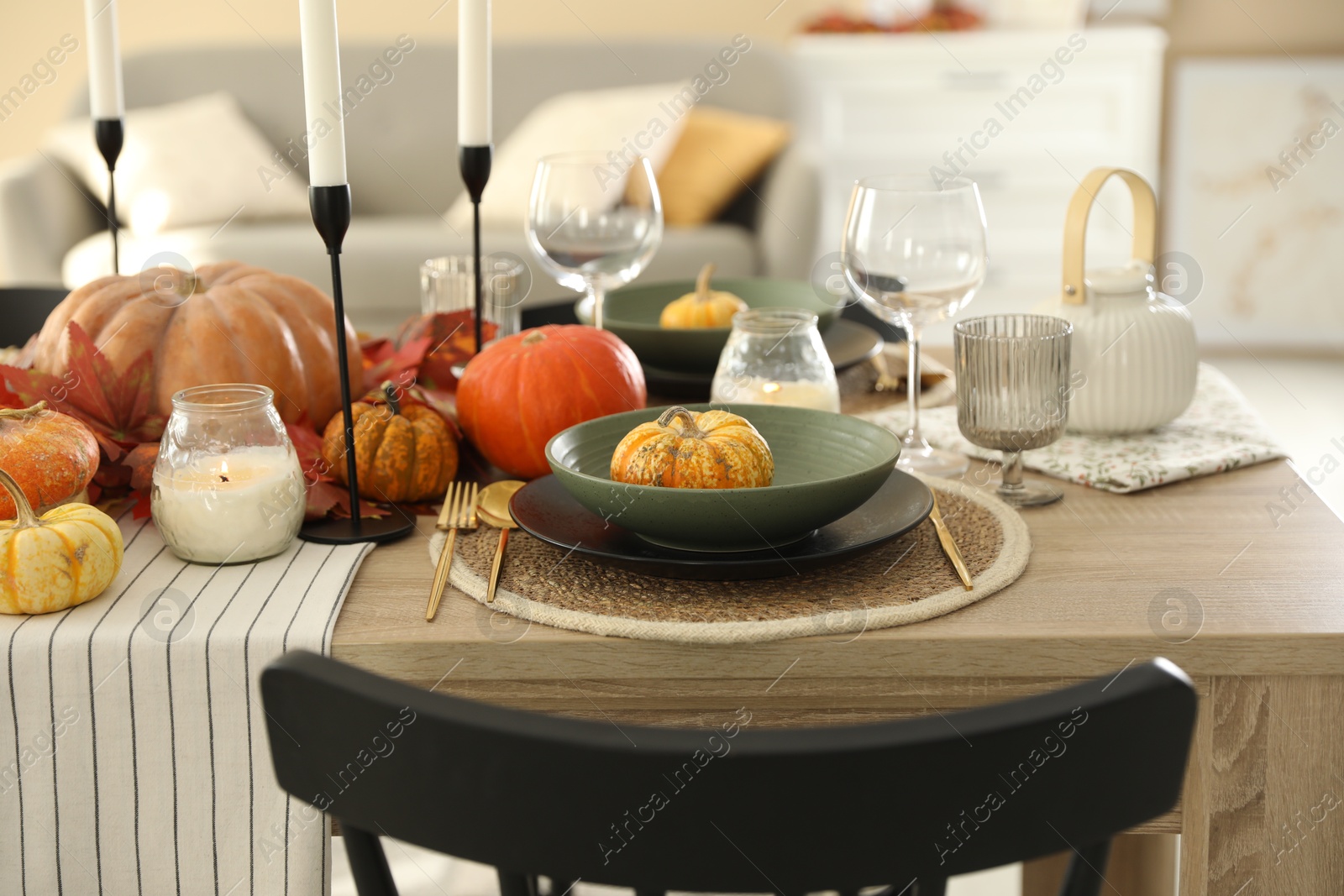 Photo of Stylish table setting with beautiful autumn decor in dining room