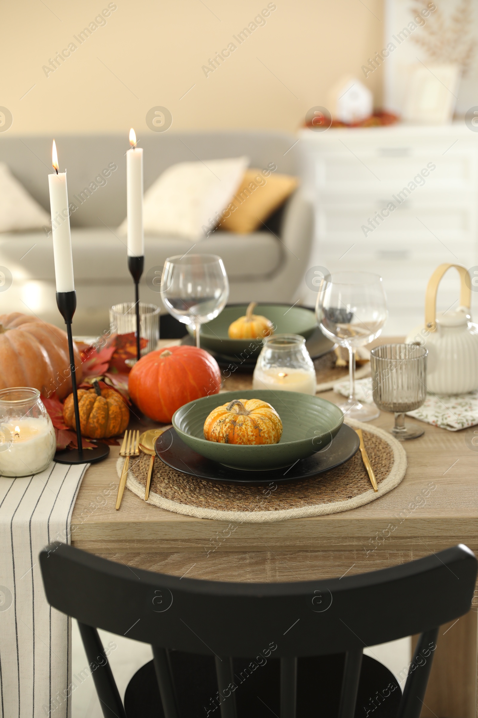 Photo of Stylish table setting with beautiful autumn decor in dining room