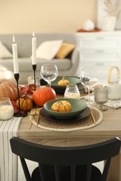 Photo of Stylish table setting with beautiful autumn decor in dining room