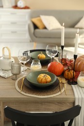 Photo of Stylish table setting with beautiful autumn decor in dining room