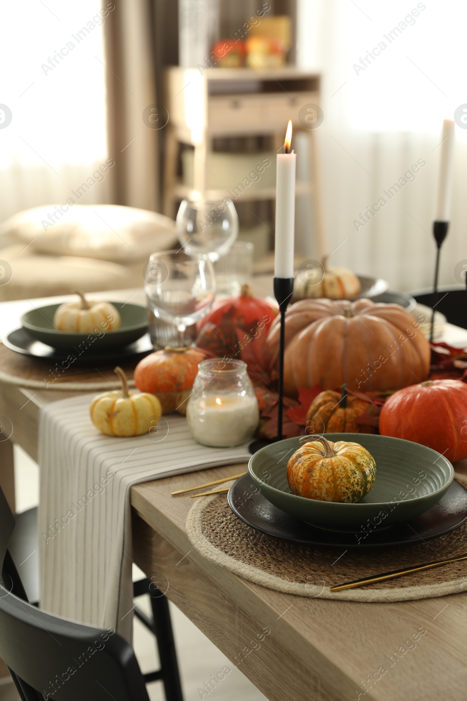 Photo of Stylish table setting with beautiful autumn decor in dining room