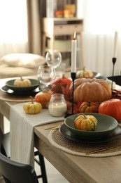 Photo of Stylish table setting with beautiful autumn decor in dining room