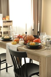 Stylish table setting with beautiful autumn decor in dining room