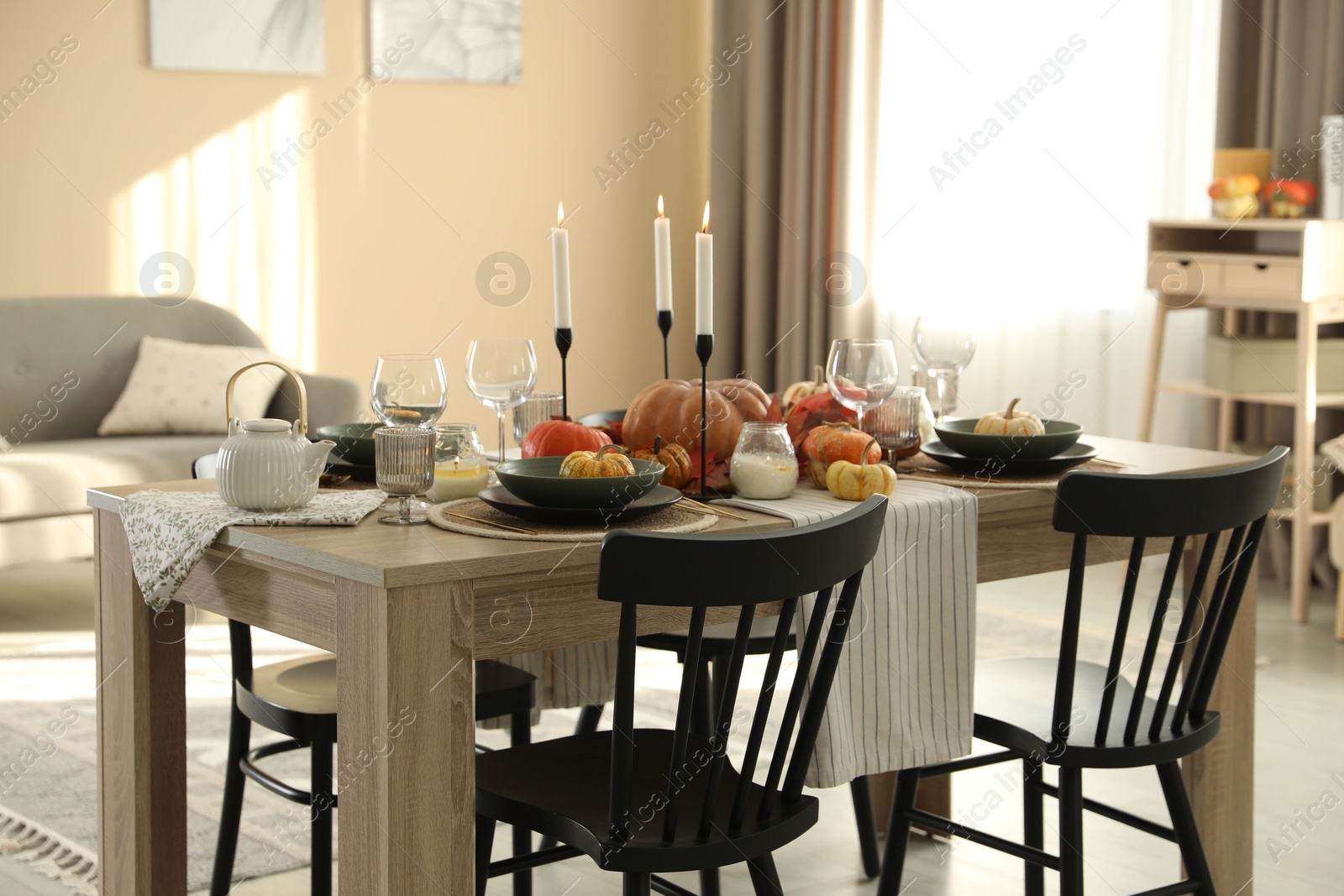 Photo of Stylish dining room with beautiful table setting and autumn decor